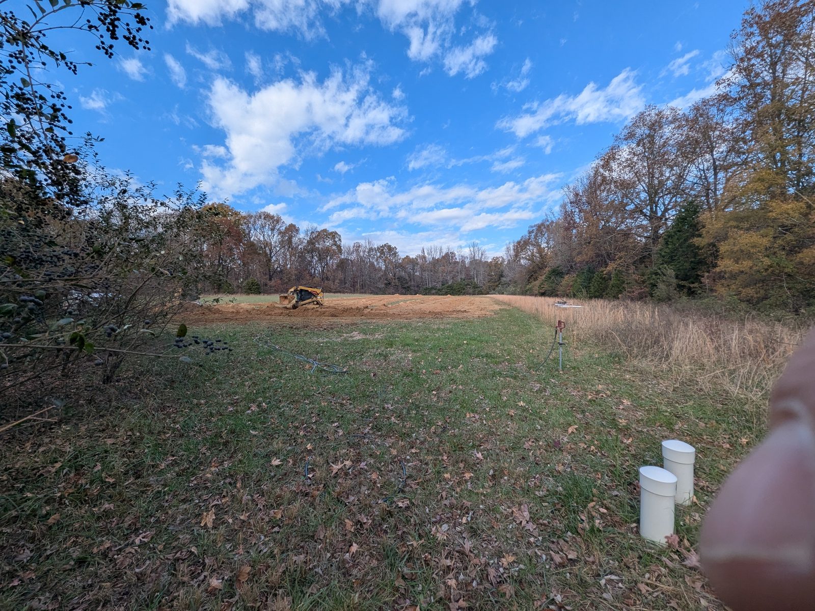 Horizontal geothermal loop field being trenched in an open field