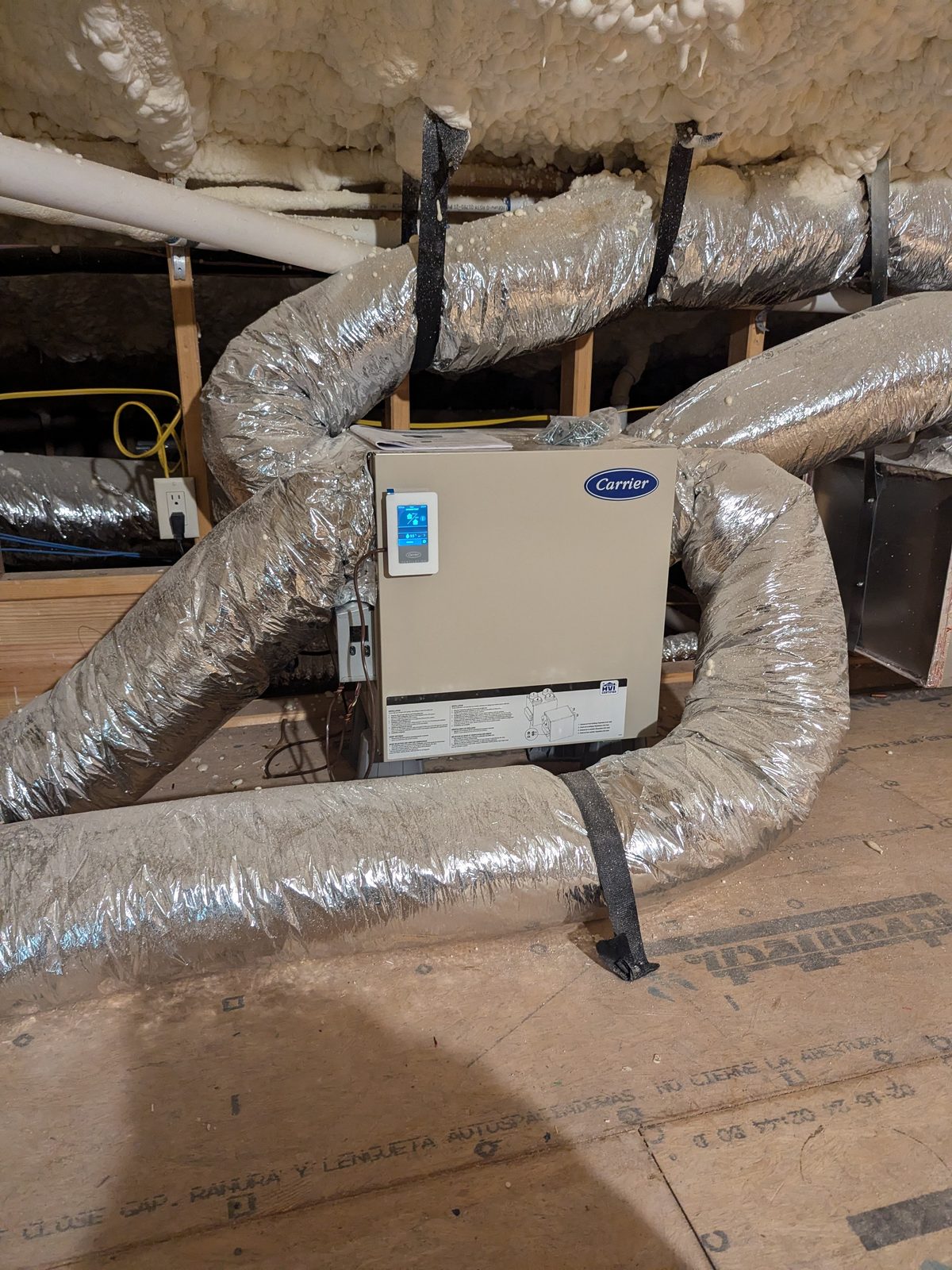 Carrier energy recovery ventilator (ERV) with digital control panel installed on ductwork, bringing in fresh outdoor air