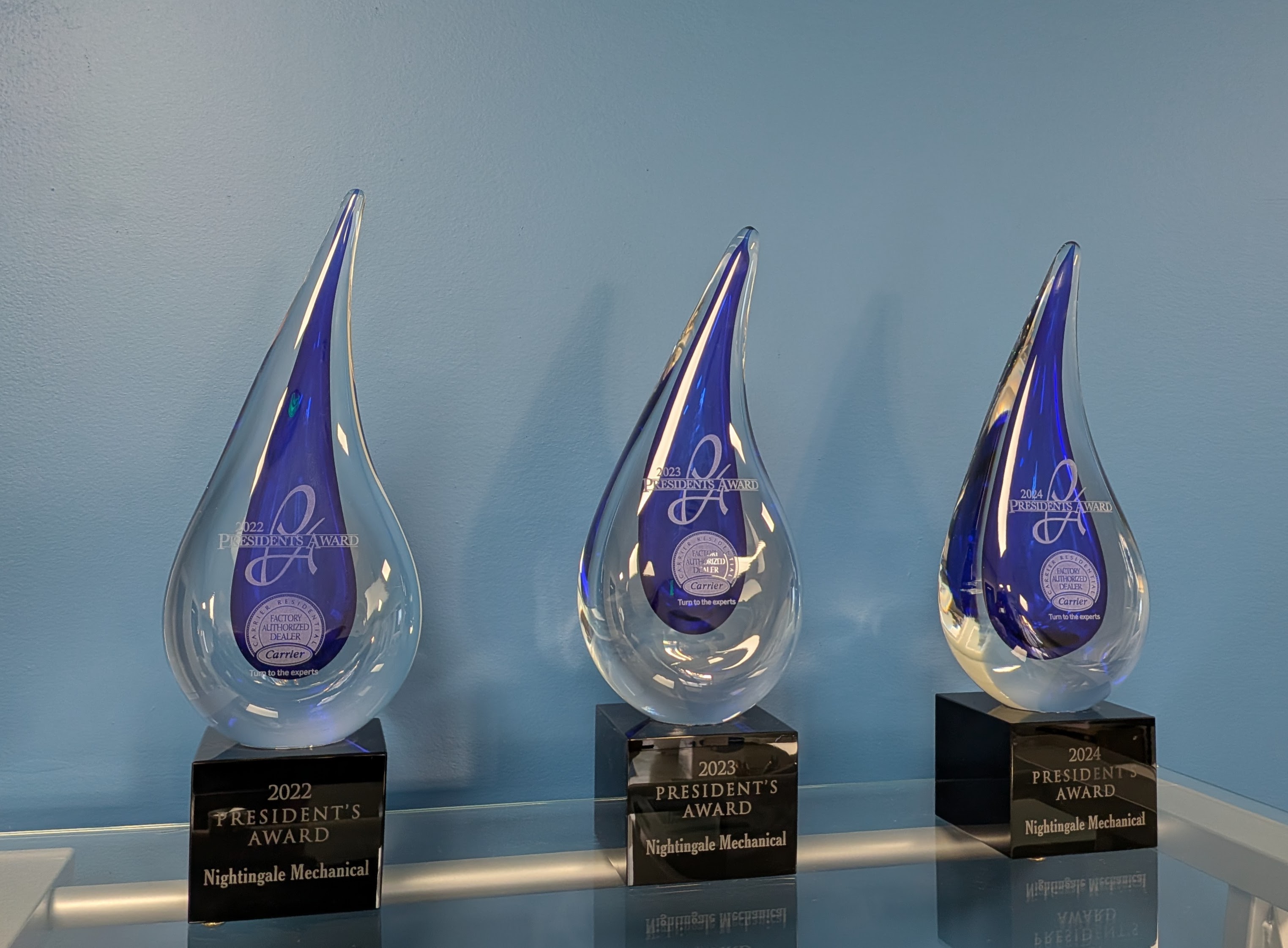 Three Carrier President's Award trophies for Nightingale Mechanical, 2022, 2023 and 2024