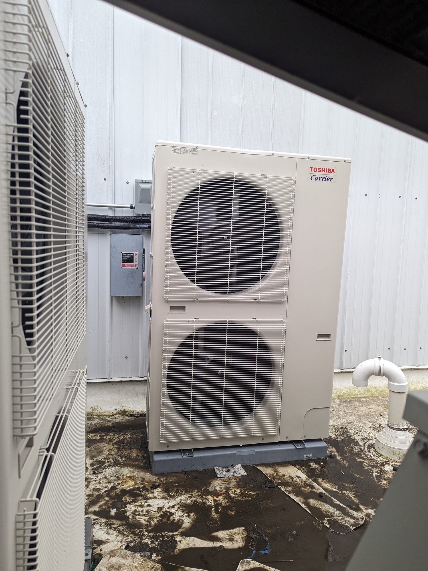 Toshiba-Carrier VRF outdoor condensing unit beside a commercial building